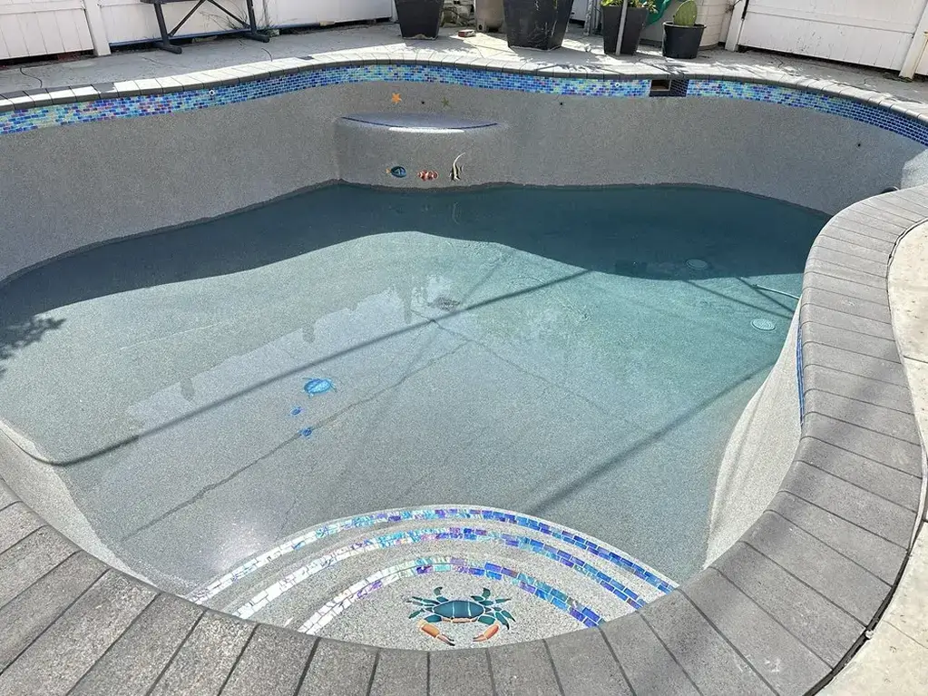 a freeform pool with water filled halfway